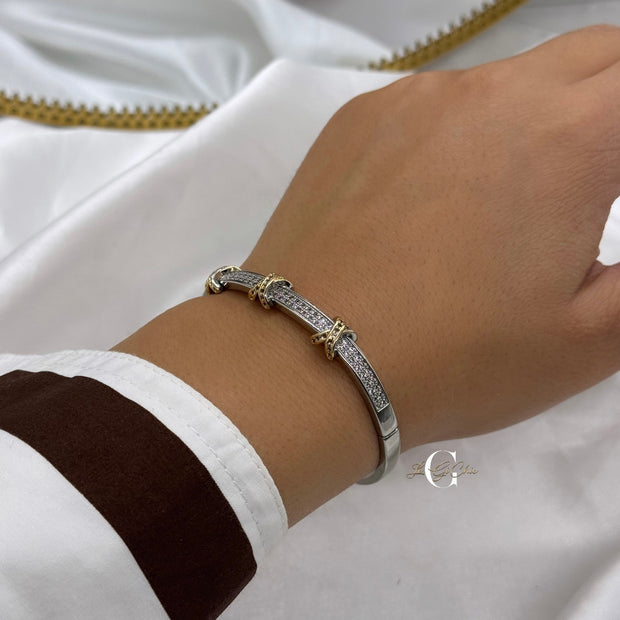 Bracciale “rigido con fascia di zirconi e incroci oro”