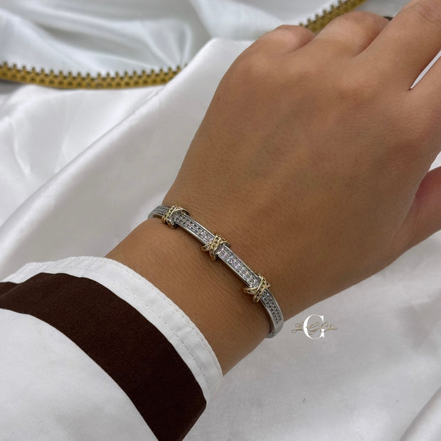 Bracciale “rigido con fascia di zirconi e incroci oro”
